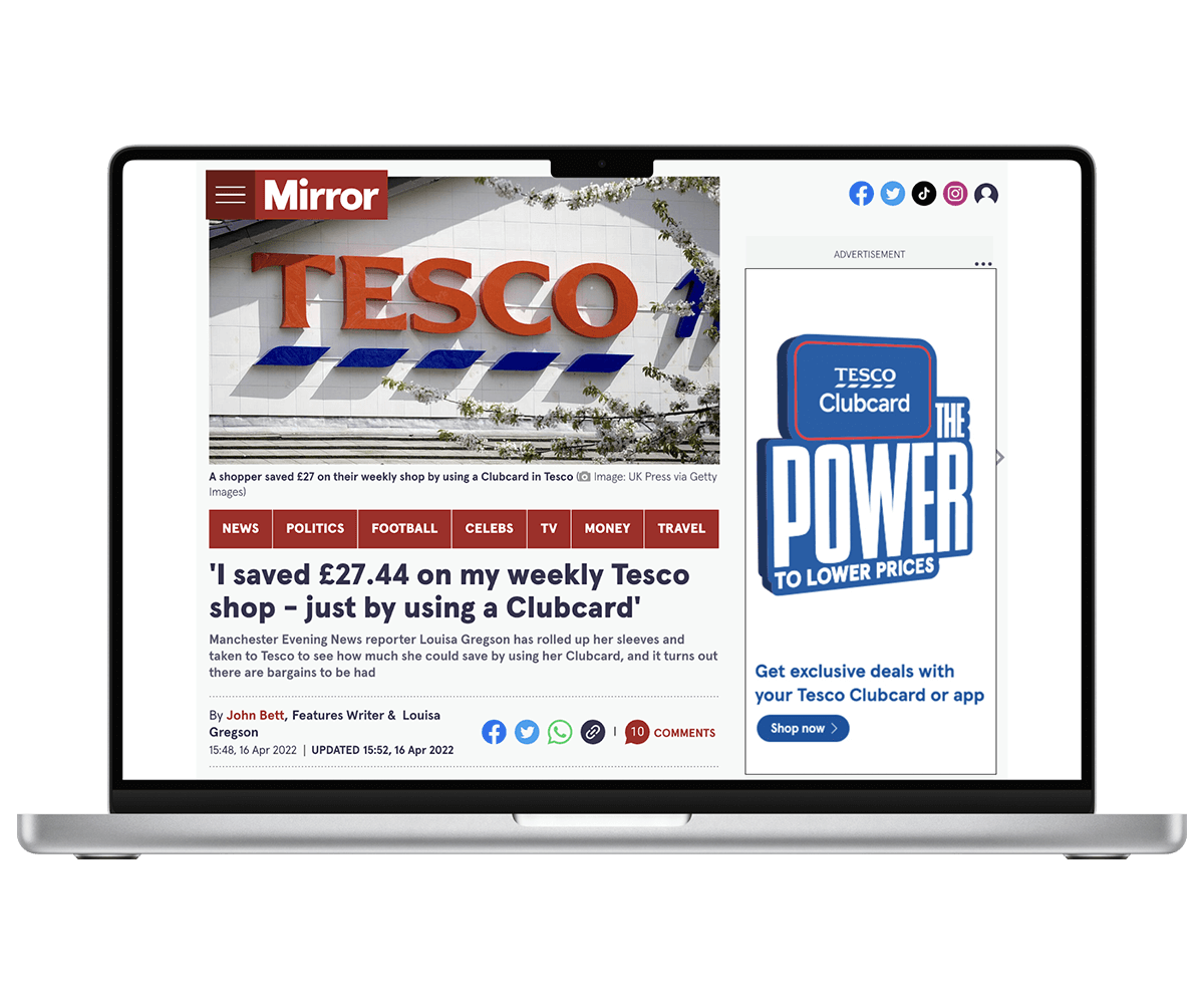 Laptop showing cost of living article on Mirror website with Tesco ad