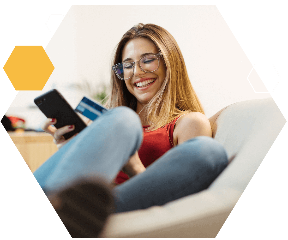 woman online shopping on her phone looking happy