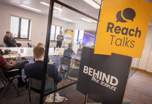 A mixed group of people sitting at the Reach Talks Behind The Scenes event.